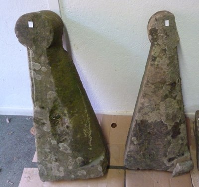 Lot 12 - A pair of buttress capping stones with round...