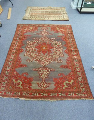 Lot 22 - An Afghan rug, central medallion on a purple...