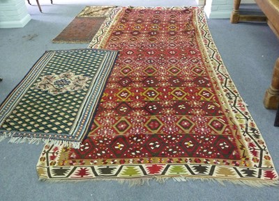 Lot 25 - A kilim rug of geometric design on a plum...