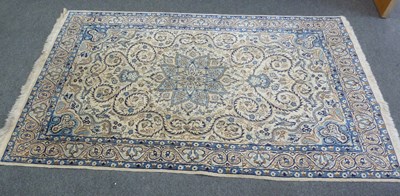 Lot 28 - An Oriental rug with blue star medallion and...