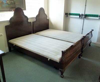 Lot 43 - A pair of mahogany single beds, the arch top...