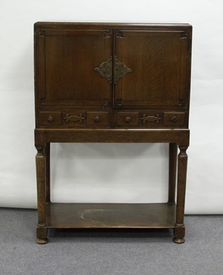 Lot 45 - An oak cupboard, enclosed by a pair of doors,...