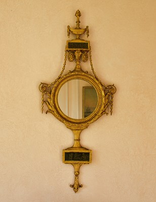 Lot 52 - An Italian carved and gilded mirror, the...