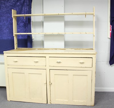 Lot 56 - A pine dresser with rack above two drawers and...