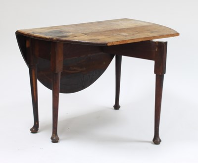 Lot 91 - A George III mahogany oval drop-leaf table, on...