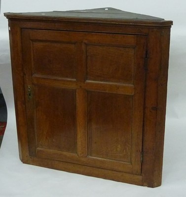 Lot 131 - A 19th Century oak corner cupboard enclosed by...