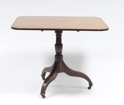 Lot 140 - A mahogany table on a turned column and tripod...