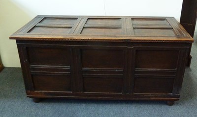 Lot 159 - An oak chest with hinged panelled cover and...