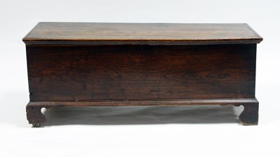 Lot 167 - An oak chest with hinged cover, on bracket...