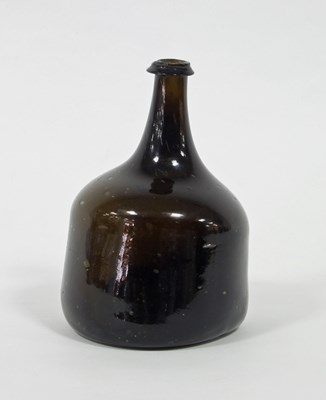 Lot 220 - An 18th Century wine bottle, brown tinted,...