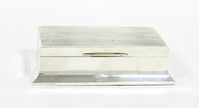 Lot 516 - An Art Deco silver cigarette box, Walker &...