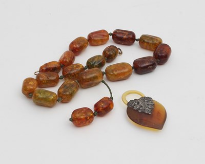 Lot 559 - An amber bead necklace, slightly graduated...