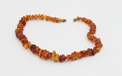 Lot 573 - An amber bead necklace, graduated from the...