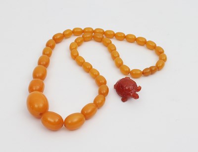 Lot 575 - An amber bead necklace, graduated from the...