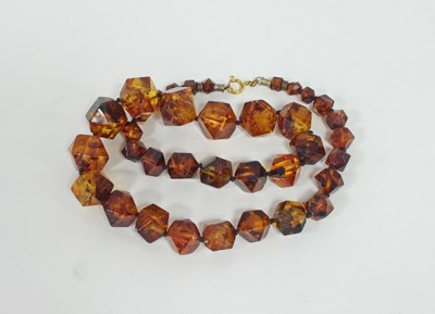 Lot 577 - A single row amber bead necklace, graduated...