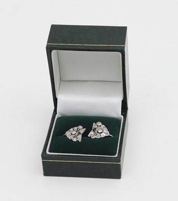 Lot 580 - A pair of diamond earrings, of geometric...