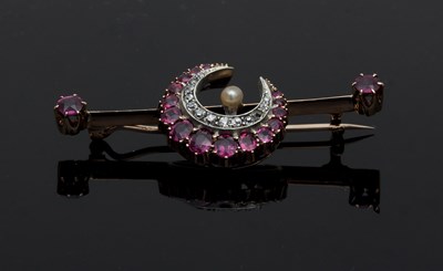 Lot 594 - An Edwardian ruby and diamond crescent brooch,...