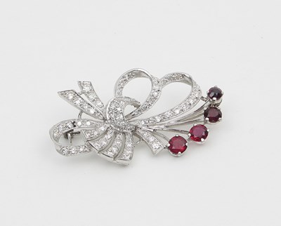 Lot 595 - A ruby and diamond brooch of stylised flower...