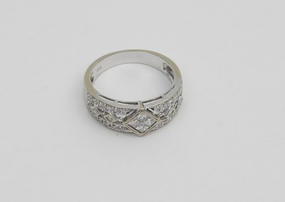 Lot 600 - A contemporary gold half-band diamond ring,...