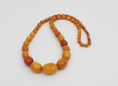 Lot 620 - A single row amber bead necklace, graduated...