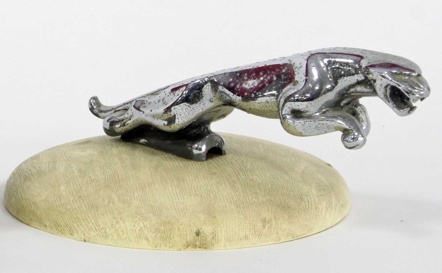 Lot 708 - A bonnet mascot modelled as a seated wolf,