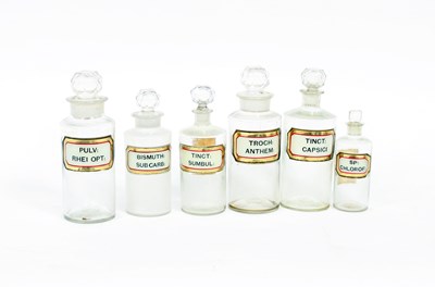 Lot 710 - Six clears glass pharmacist's bottles, labled,...