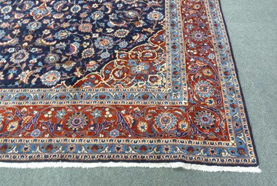 Lot 10 - A large Oriental carpet with central madder...