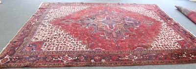 Lot 12 - An Iranian wool carpet with central medallion...