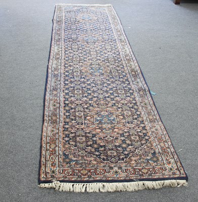 Lot 18 - A Hamadan runner with allover field of flowers...