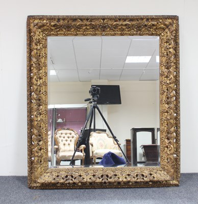 Lot 49 - A carved gilt wood framed mirror, the bevelled...