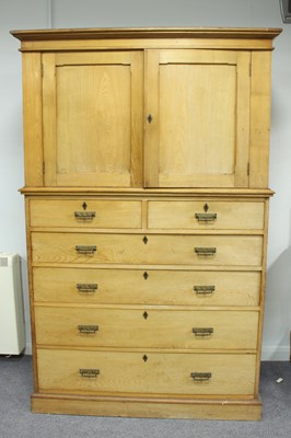 Lot 102 - An Edwardian pine linen press, enclosed by...