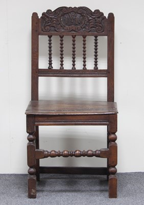 Lot 172 - An oak side chair, the cresting carved,...