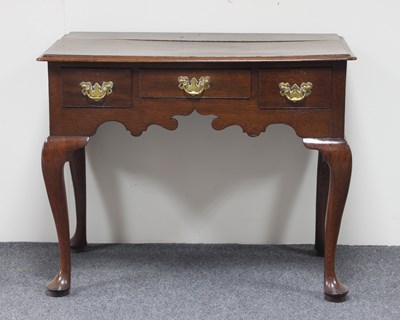 Lot 177 - A late 18th Century oak lowboy, the...