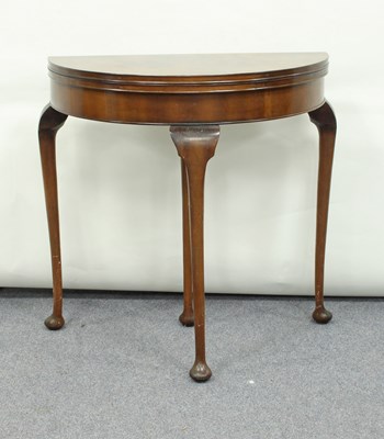 Lot 239 - A walnut half-round card table on cabriole...