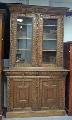 Lot 257 - A late 19th Century carved oak bookcase, with...