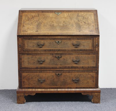 Lot 284 - A figured walnut bureau of Queen Anne design...