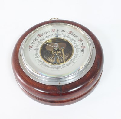 Lot 324 - A 20th Century aneroid barometer in a circular...