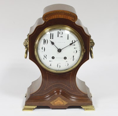 Lot 331 - An Edwardian inlaid cased mantel clock, the...