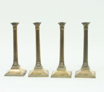 Lot 381 - A set of four 18th Century brass candlesticks...