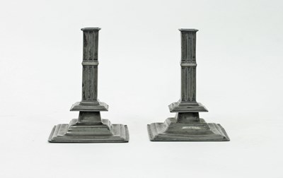 Lot 387 - A pair of square based pewter candlesticks,...