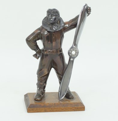 Lot 417 - A patinated table lighter modelled as Biggles,...