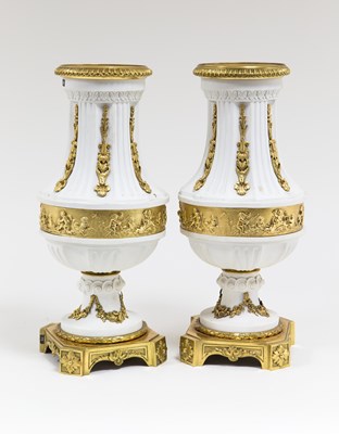 Lot 765 - A pair of Sevres bisque porcelain urns with...