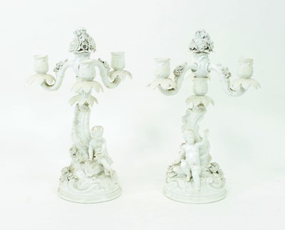 Lot 789 - A pair of German white glazed three-branch...