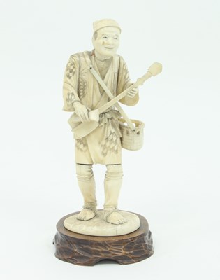 Lot 856 - A Japanese carved and engraved figure, Meiji...