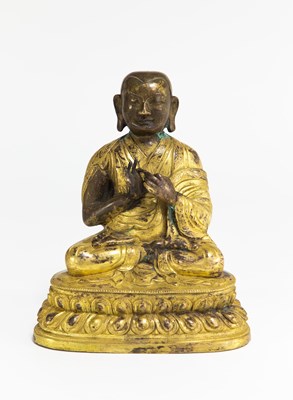 Lot 869 - A bronze parcel gilt figure of the seated...