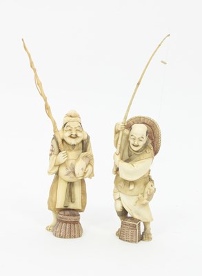 Lot 882 - Two Japanese ivory okimono depicting fishermen...