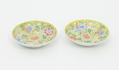 Lot 913 - A pair of Chinese famille jaune saucers,...