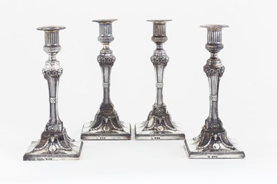 Lot 1026 - A set of four George III silver candlesticks,...