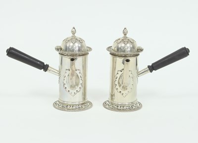 Lot 1033 - A pair of silver chocolate pots, Goldsmiths &...