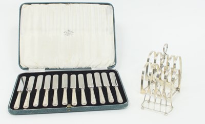 Lot 1076 - A pair of silver toast racks, Sheffield 1933,...